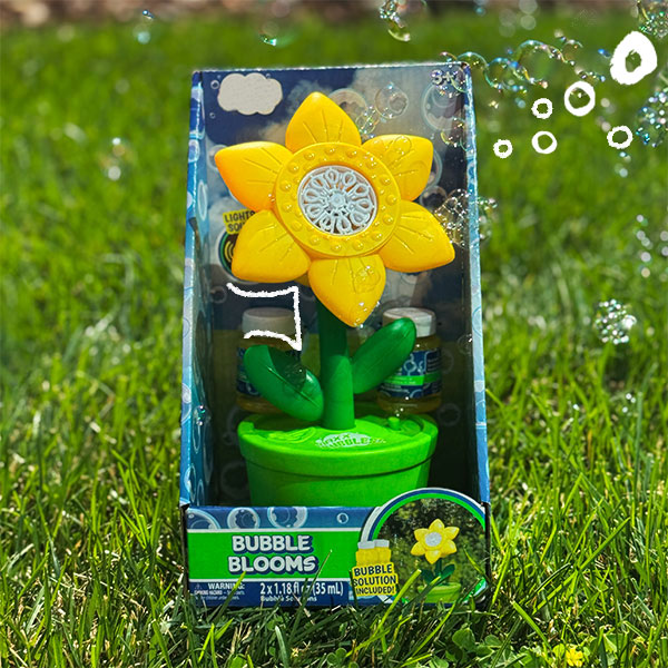 Yellow flower bubble machine on grass.  