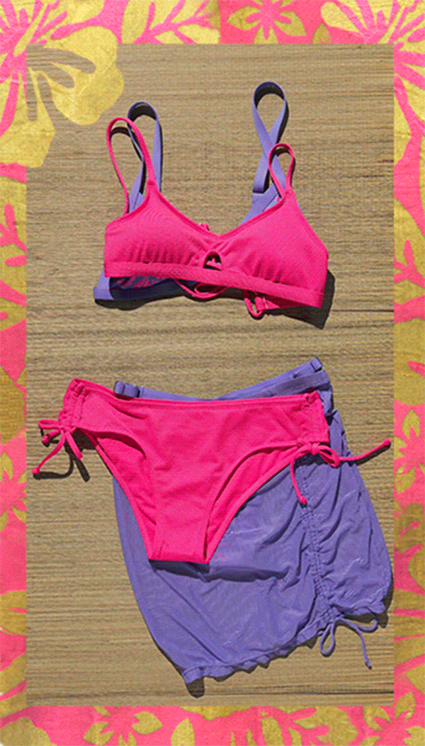 Various bikinis on a flower pink and gold towel. 