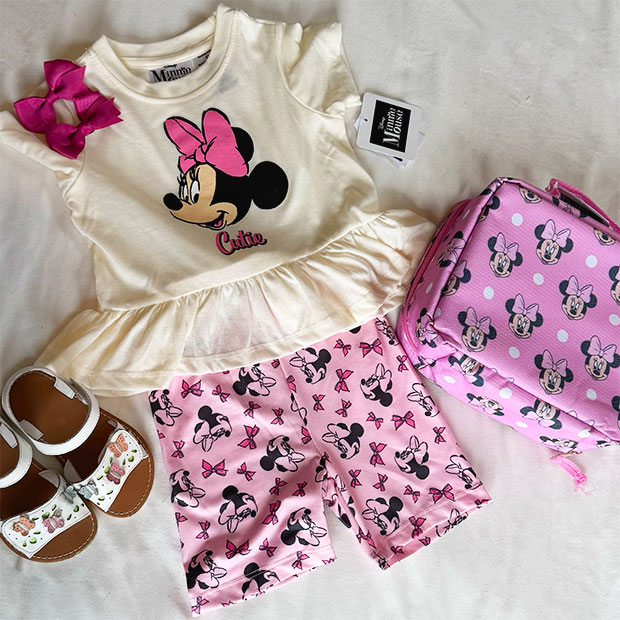 Pink Disney’s Minnie shorts summer outfit with sandals and lunch pail.  