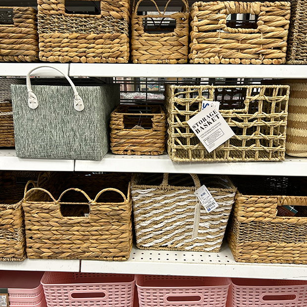 Shelf of rattan and pink plastic baskets found in store at Ross. 