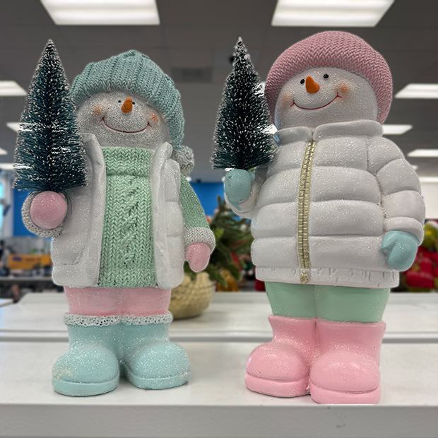 Two snowman figurines dressed in pastel winter clothes, each holding a small green tree,  found in store at Ross.  