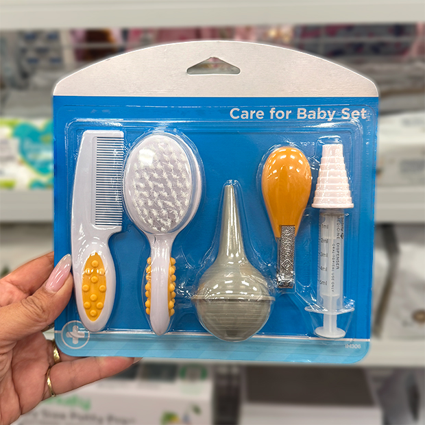 Baby care grooming set in blue packaging, including a comb, brush, nasal aspirator, medicine dropper, and syringe, found in store at Ross.  