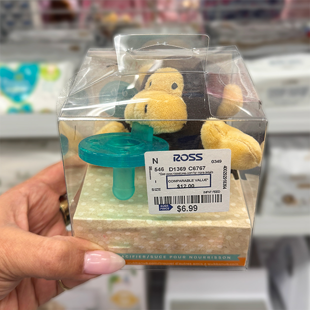 Packaged baby plush toy and pacifier set inside a clear plastic box found in store at Ross.  