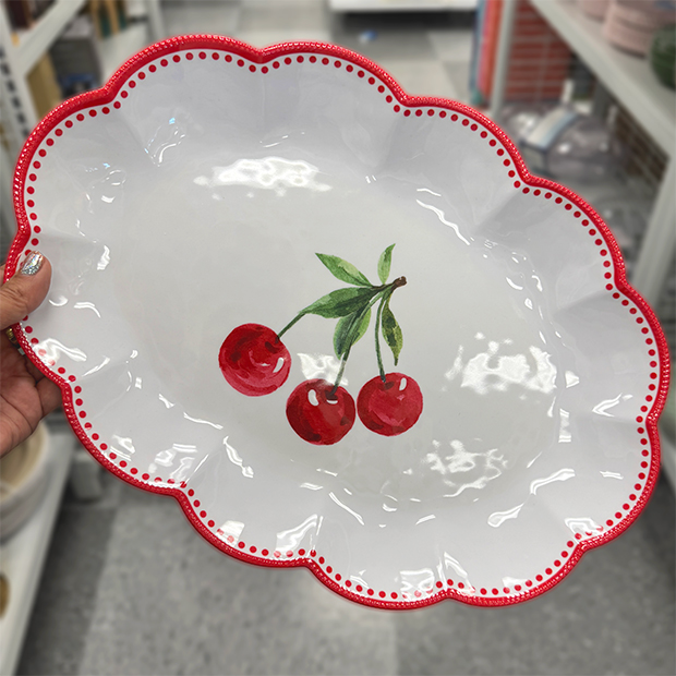 White scalloped serving plate with red trim and a painted cherry design, found in store at Ross. 