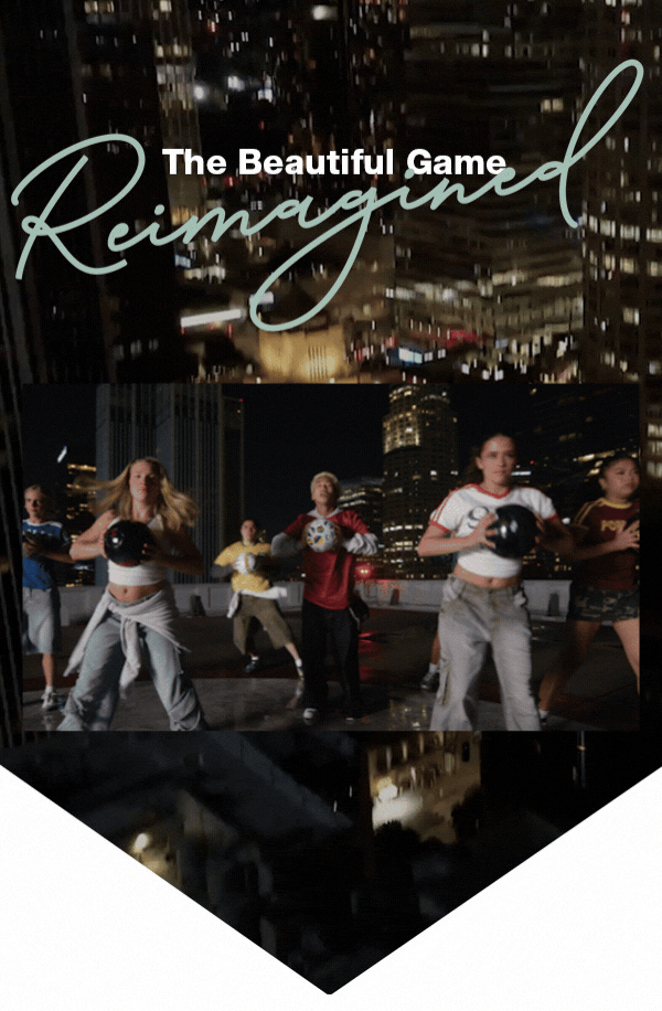 Nighttime city scene with a group performing choreographed soccer moves on a rooftop, holding balls under bright lights. Overlaid text reads ‘The Beautiful Game Reimagined.