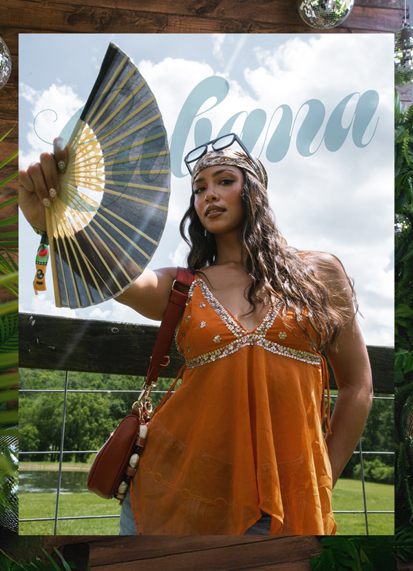 Cabana. Person in festival fashion holding a fan.