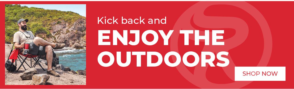 Person relaxing in camping chair by water with text: Kick back and Enjoy the outdoors - shop now 