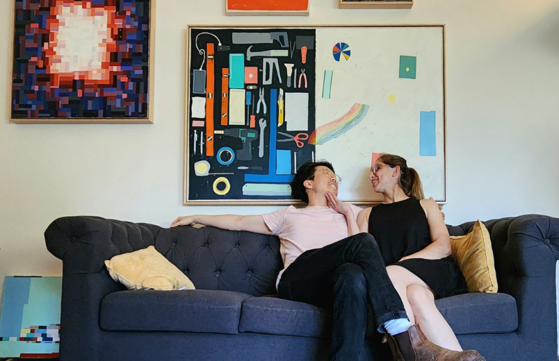 photo of couple on a couch with art
