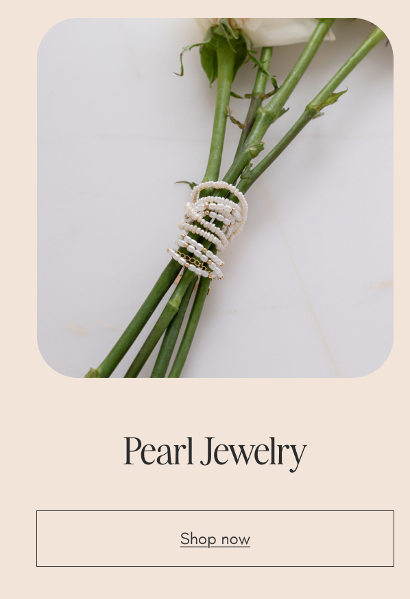 Freshwater pearl jewelry styled on white rose stems. Shop pearl jewelry.