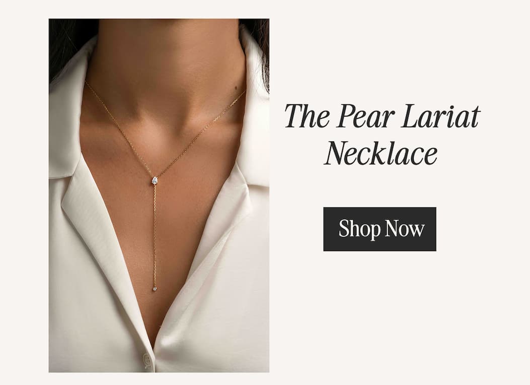 The Pear Lariat Necklace — dainty gold Y-chain with a pear-cut CZ and bezel drop. Shop Now.