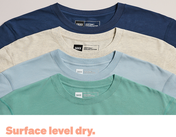 Stack of SAXX cooling cotton t-shirts in multiple colors with “Surface level dry” text overlay.