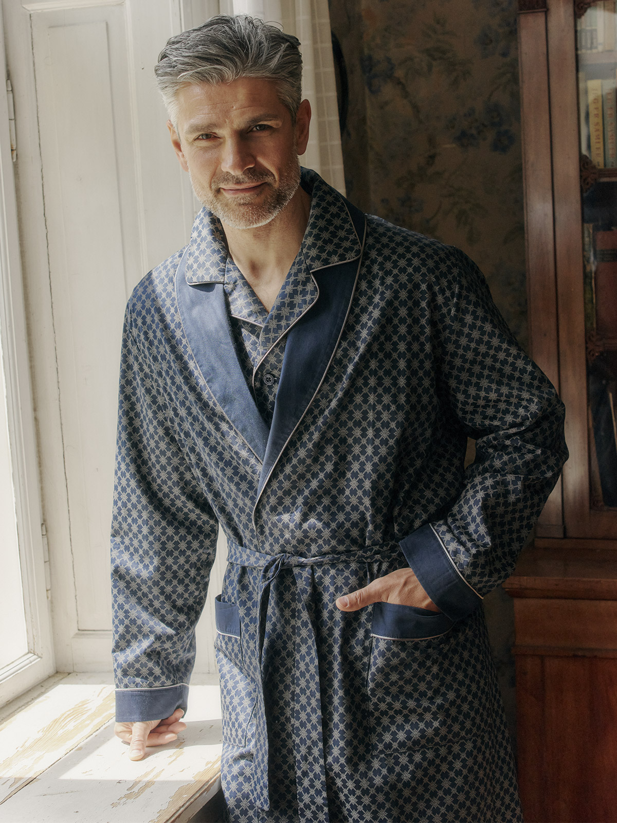 This pajama and matching robe duo is designed in Copenhagen in Navy with a Gray print. Next-level cozy!