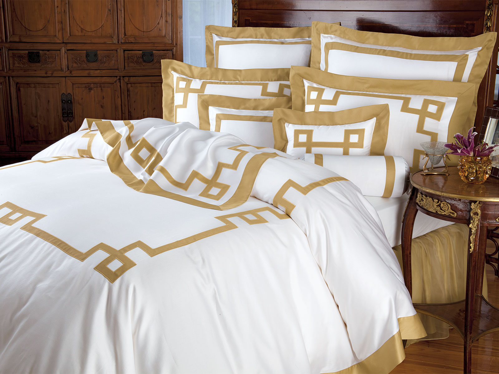 An intriguing Gold symbol with embroidered edging is appliquéd on luminous White Egyptian cotton sateen, 600tc.
