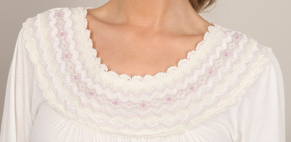 Hand-smocked for you in Peru, with striking detailing along the neckline