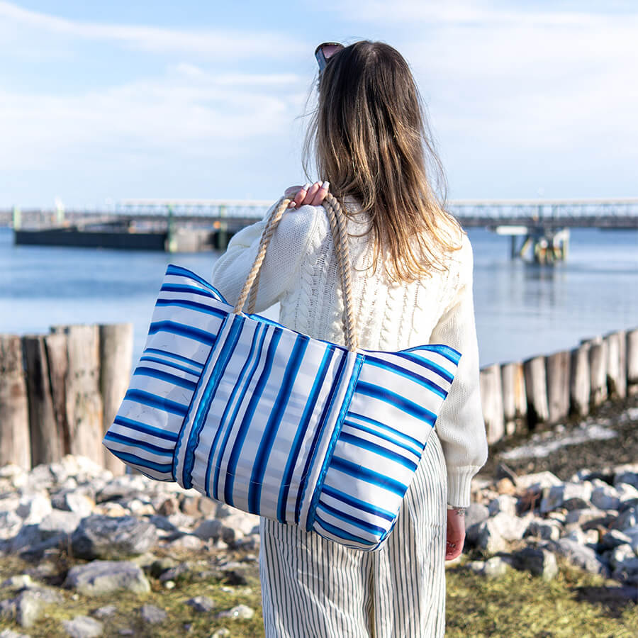 A woman carrying the Santorini Stripe Pier Tote