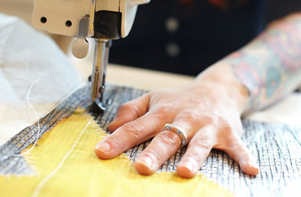 Close-up of someone sewing a Sea Bag