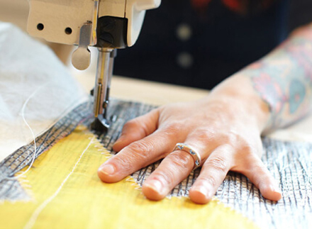 Close-up of someone sewing a Sea Bag