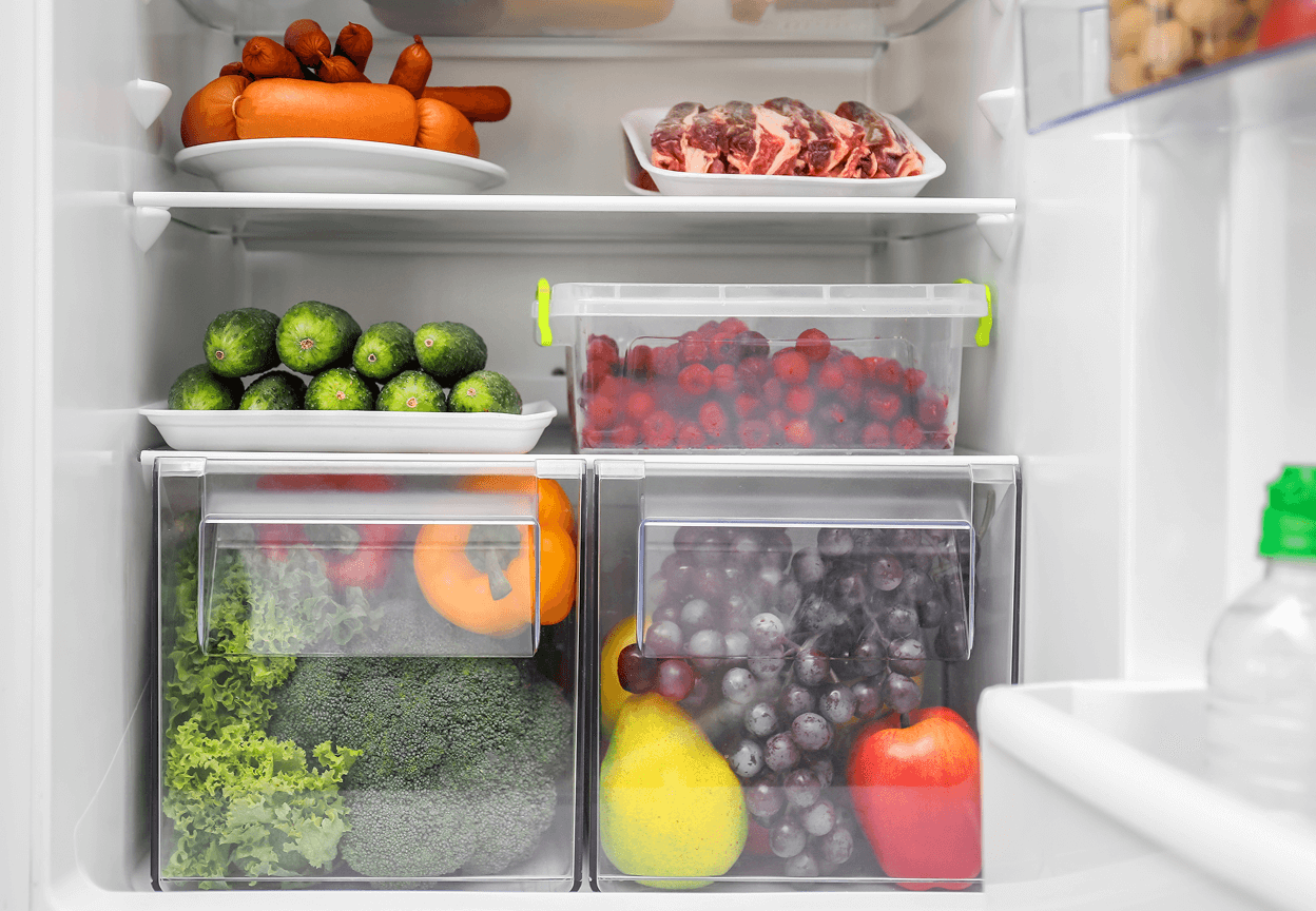 A fridge that has fruits, vegetables, meat and cheeses