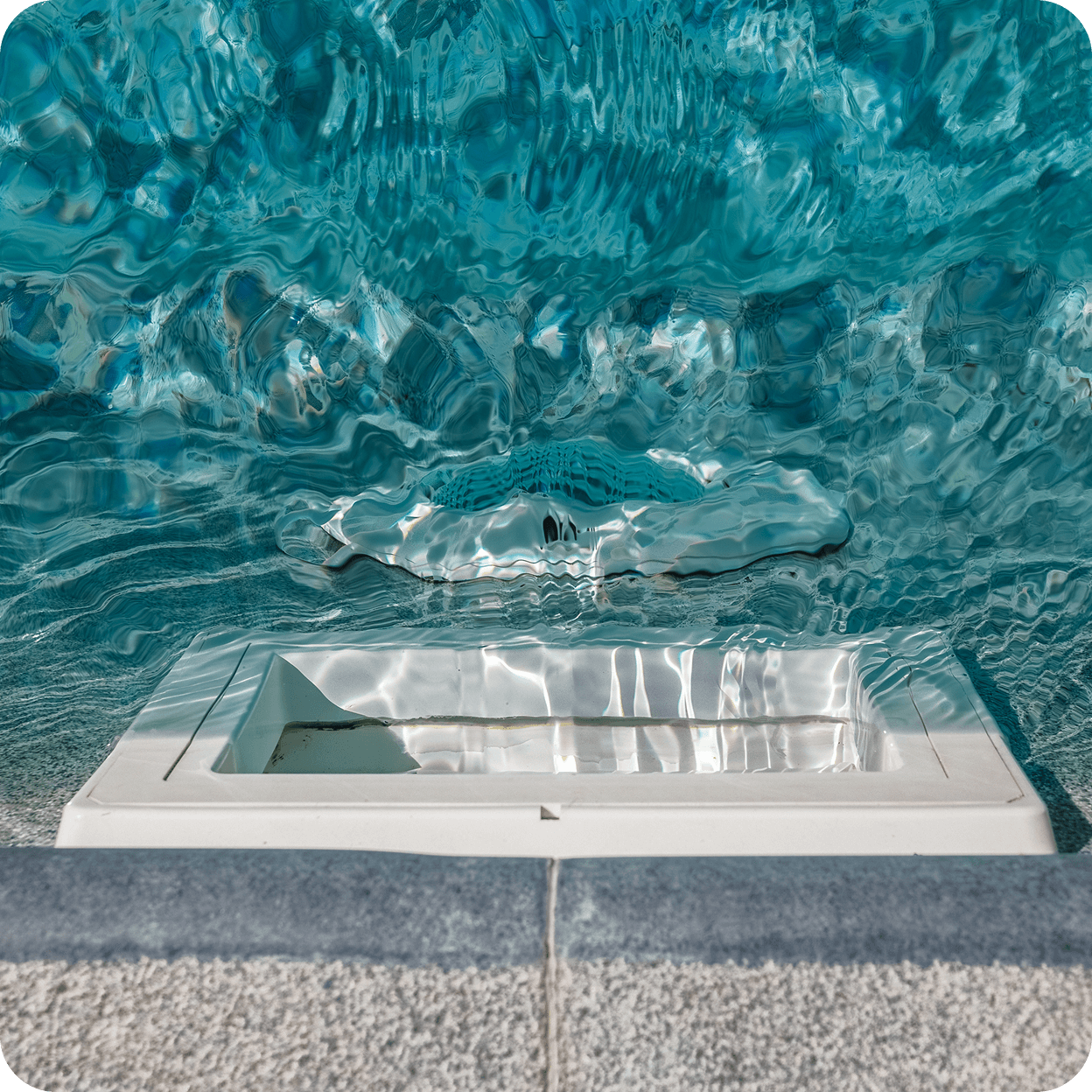 A pool filter opening on the side of a pool