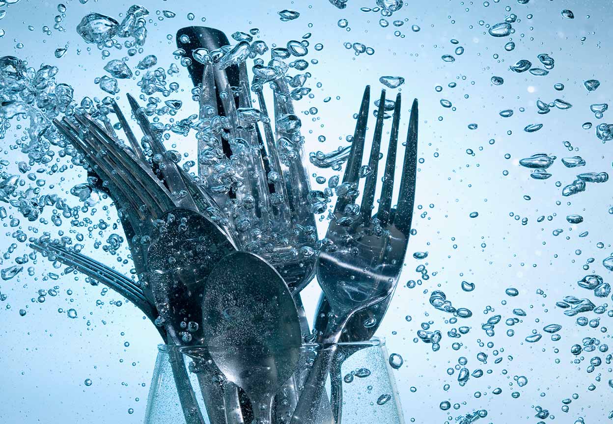 Submerged silverware that are placed inside of a wine glass