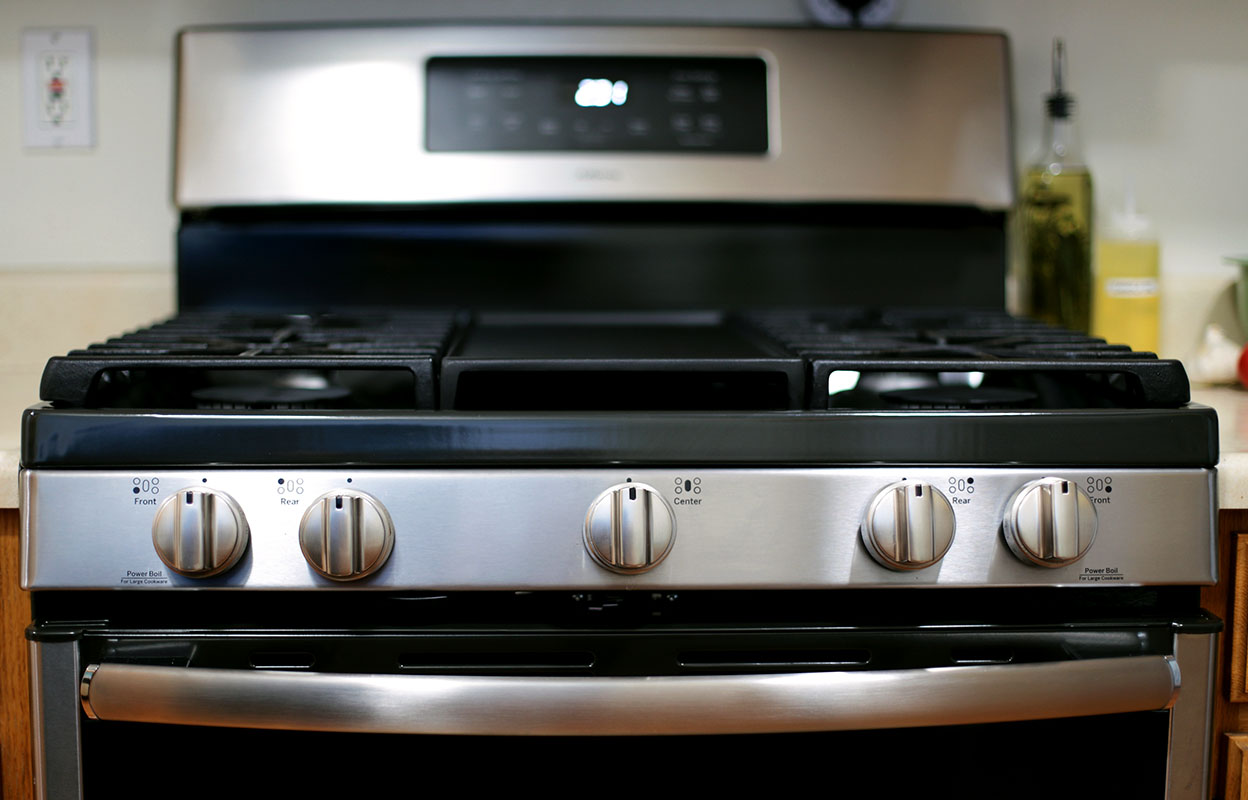 Close-up view of a stainless steel gas range with front control knobs