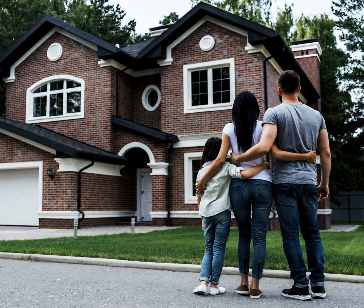A family looking at their house from the street