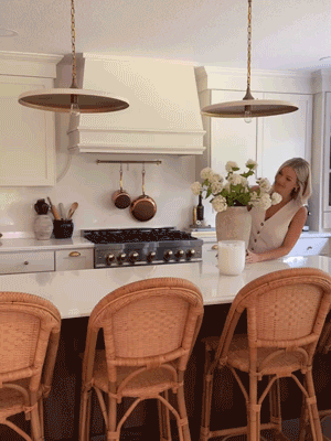 Woman in kitchen with 2 Victor Pendants