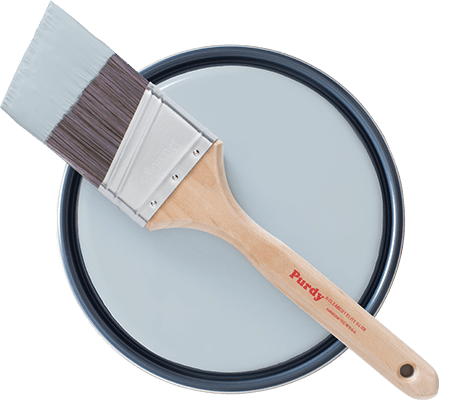 Topview of Purdy brush laying on open paint can showing Upward paint.