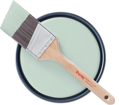 Topview of Purdy brush laying on open paint can showing Slow Green paint.
