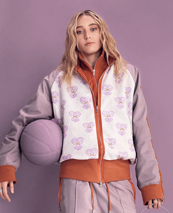 Paige Bueckers holding a basketball painted in Radiant Lilac.