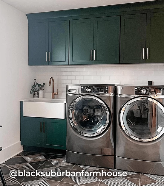 Laundry room with stand-up front-loading washer & dryer, utility sink and cabinets painted in Dard Hunter Green. @blacksuburbanfarmhouse.