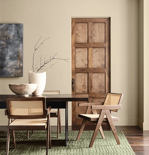 Mid-century modern dining set, with bowl and vase on top, in dining room painted in Universal Khaki.
