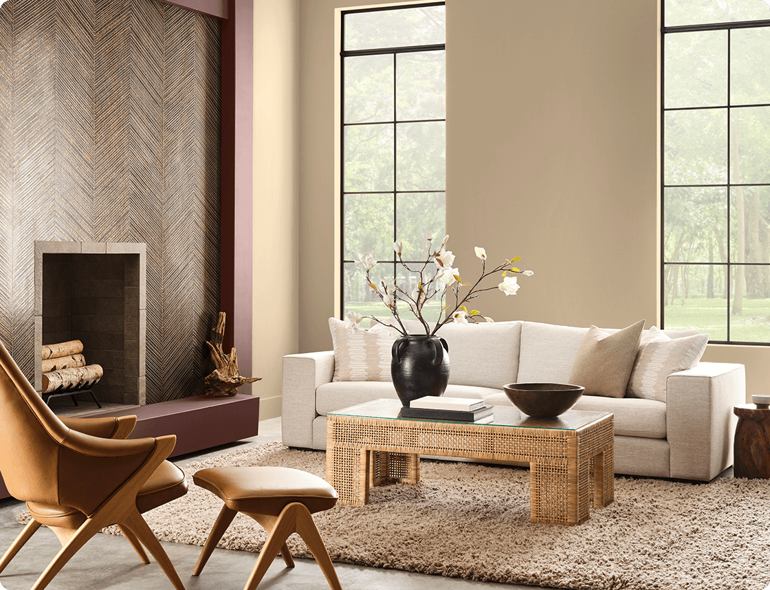 Universal Khaki painted living room with white couch and mid-centry modern chair in front of a tiled fireplace.