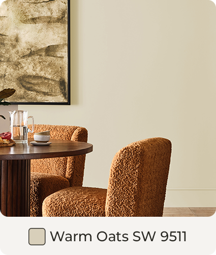 Round table, Burnt Orange chairs and abstract painting within room painted in Warm Oats. Color Swatch. Warm Oats SW 9511.