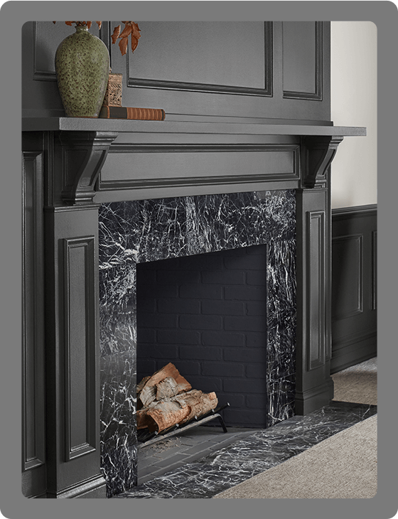 Black marble fireplace with Iron Ore painted traditional-style surround.