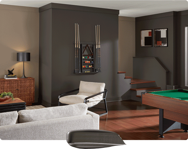 Color swipe overlapping photo of living room and home game room painted in Sealskin.
