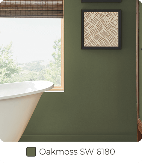 White tub in front of window within bathroom painted in Oakmoss SW6180.
