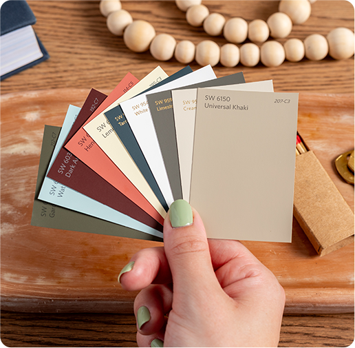 Hand holding Universal Khaki color chip along with other colors from the Color of the Year palette.