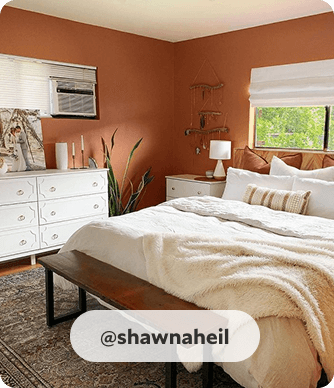 Cozy bedroom, with platform bed, bench, white dresser and white bedside table, painted in Cavern Clay. @shawnaheil.