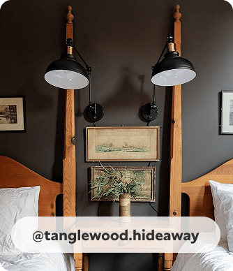Desk lamp style wall sconces, between twin beds, on Black Fox painted wall in traditional bedroom. @tanglewood.hideaway.