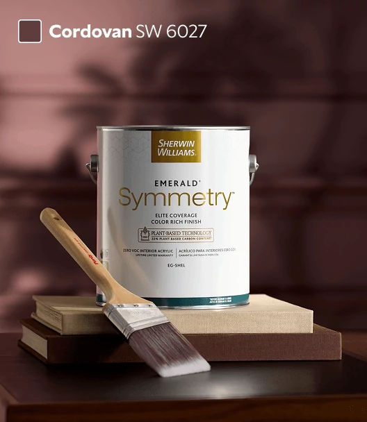 Symmetry™ paint can on top of book stack with Purdy® brush in front of siding painted in Cordovan.