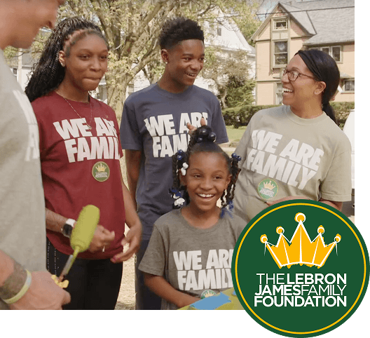 Mother with son and two daughters all wearing we are family t-shirts. The Lebron James Family Foundation logo.
