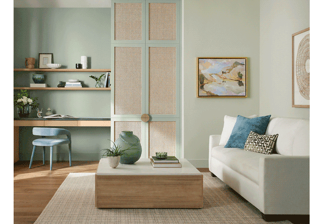 Wicker and light wood furniture in light & airy style living room and kitchen with accent walls and cabinets painted in Liveable Green.