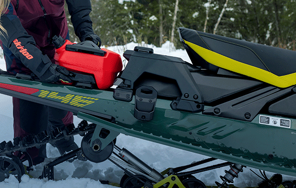 Rider installing accessories on a sled
