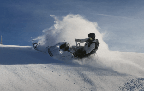 Person riding a Ski-Doo in the snow