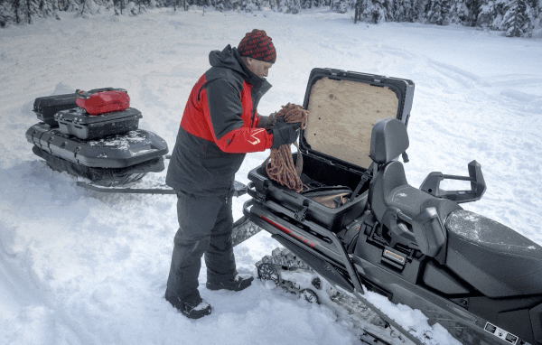 Rider loading Ski-Doo cargo box