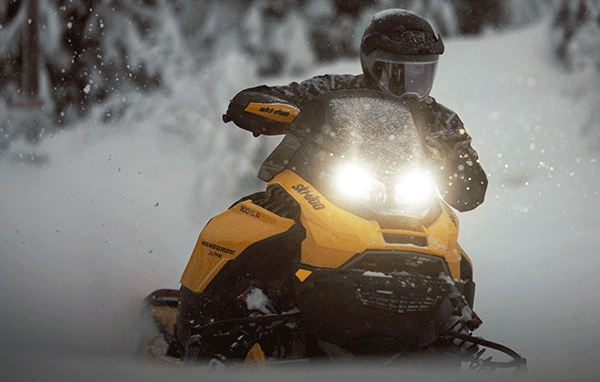 A rider with a Ski-Doo model in the snow