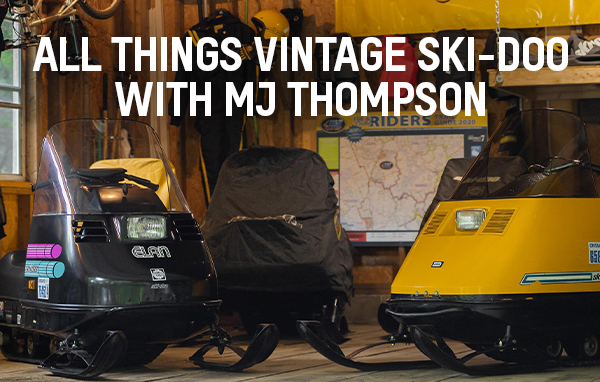 Three vintage Ski-Doo sleds in a garage