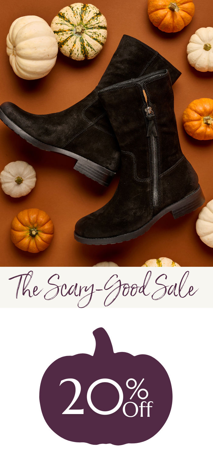 The Betty black suede boot surrounded by white and orange pumpkins on a warm brown background. Below, text reads “The Scary-Good Sale” and a dark purple pumpkin graphic shows “20% Off.