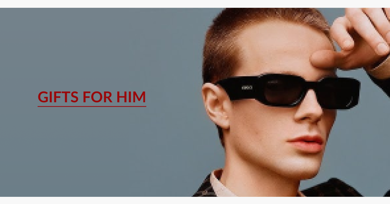 Gifts for him section featuring a model wearing black designer sunglasses against a blue-gray background.